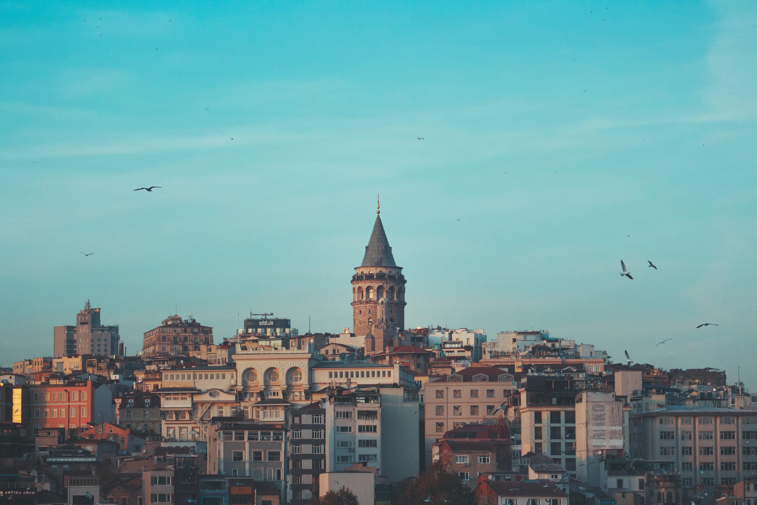 Beautiful cityscape featuring the iconic Galata Tower under a blue sky in Istanbul.